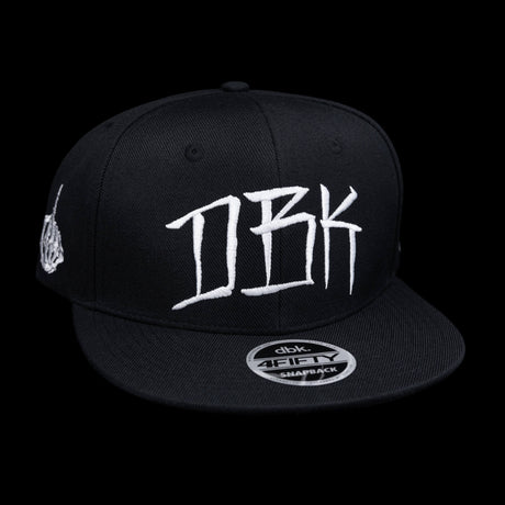 Black snapback cap front view with large white DBK graffiti-style logo