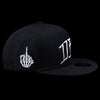 Black snapback cap side view with white flame hand-style emblem