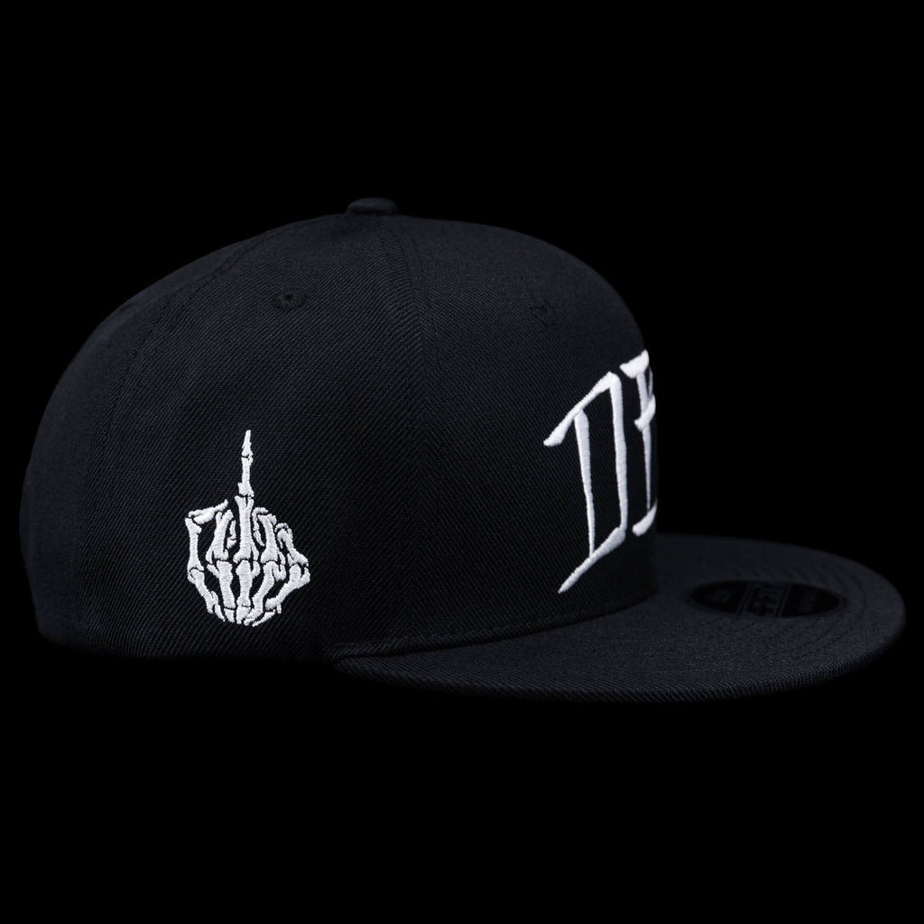 Black snapback cap side view with white flame hand-style emblem