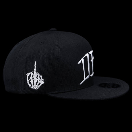 Black snapback cap side view with white flame hand-style emblem