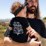 Black baby bodysuit worn by toddler, white graphic text on the back
