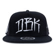 Black trucker cap with large white DBK logo and mesh side panels