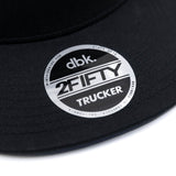 Black trucker cap circular 2FIFTY TRUCKER logo patch on brim