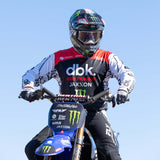 Motorcycle gloves on handlebars, black-and-white design with red highlights.