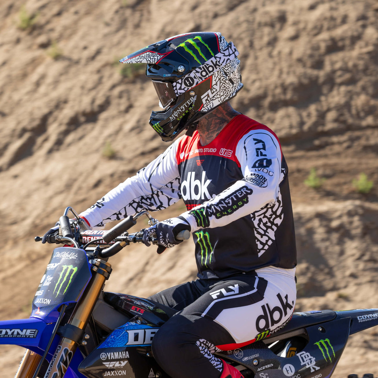 Motocross pant on rider, black with white paneling and curved knee armor