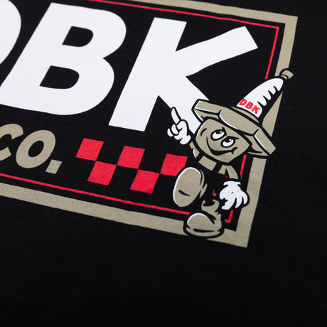 Close-up of DBK Moto Co. logo graphic on a black T-shirt back.