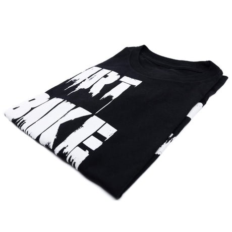 Black graphic T-shirt folded with large white diagonal stripes print