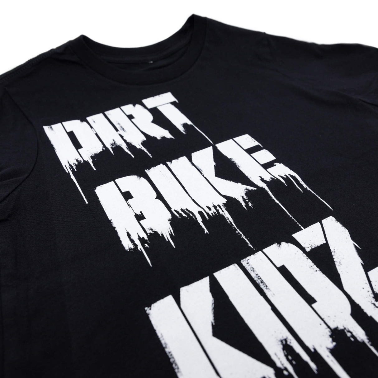 Youth premium tee close-up: black shirt with white distressed "DIRT BIKE" graphic
