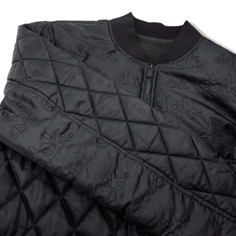 Premium quilted jacket with full-zip front, ribbed collar, and repeating dbk logo print