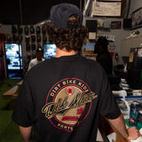 Slugger T-shirt on model in black with large back circular logo graphic