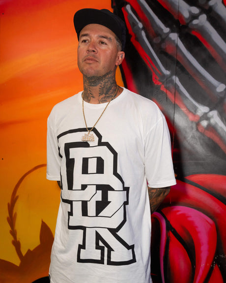 White crewneck T-shirt with black stacked logo graphic, worn by a model