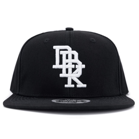 Black snapback cap with centered white embroidered DBK logo and curved brim