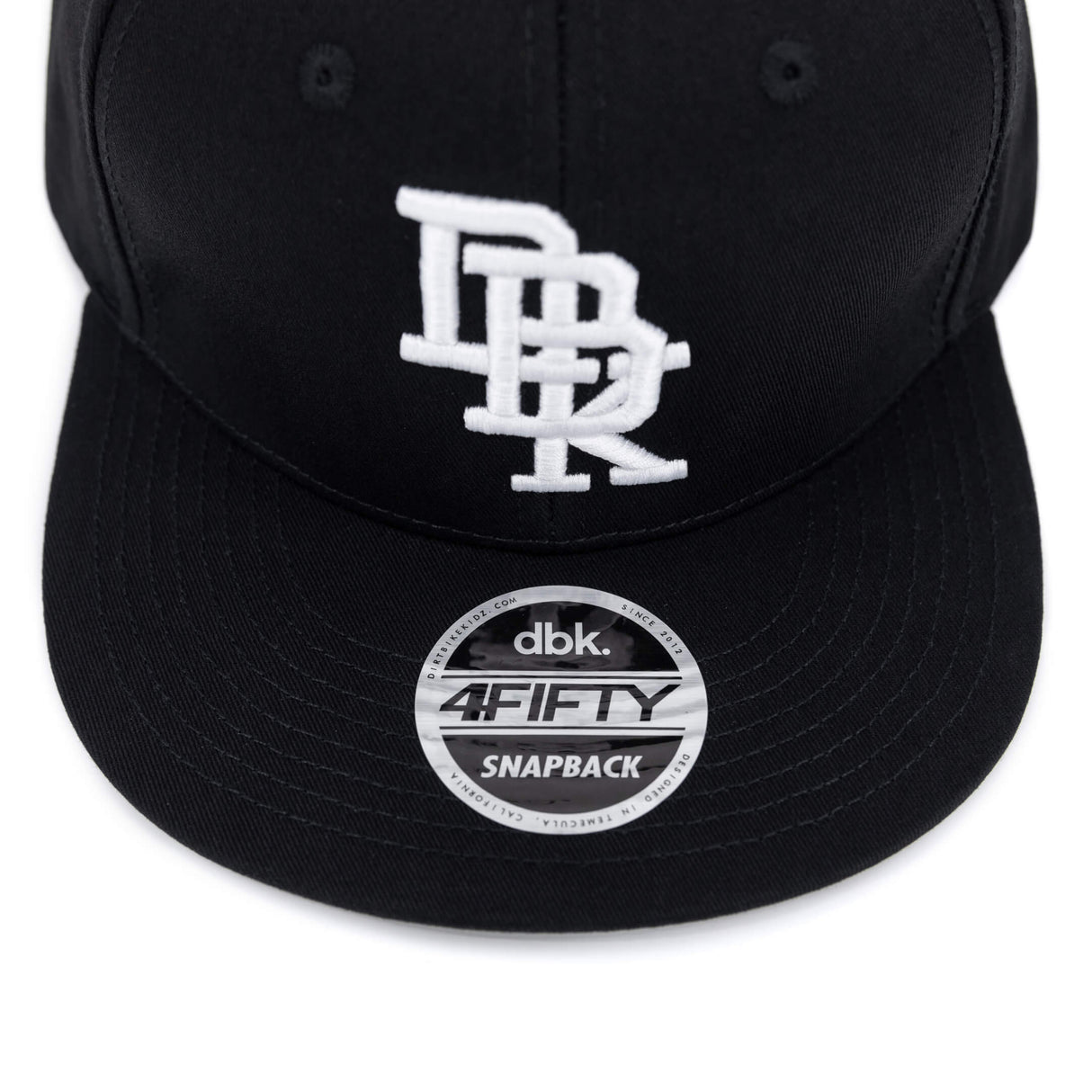 Black snapback cap front with white logo and circular dbk. 4FIFTY SNAPBACK patch