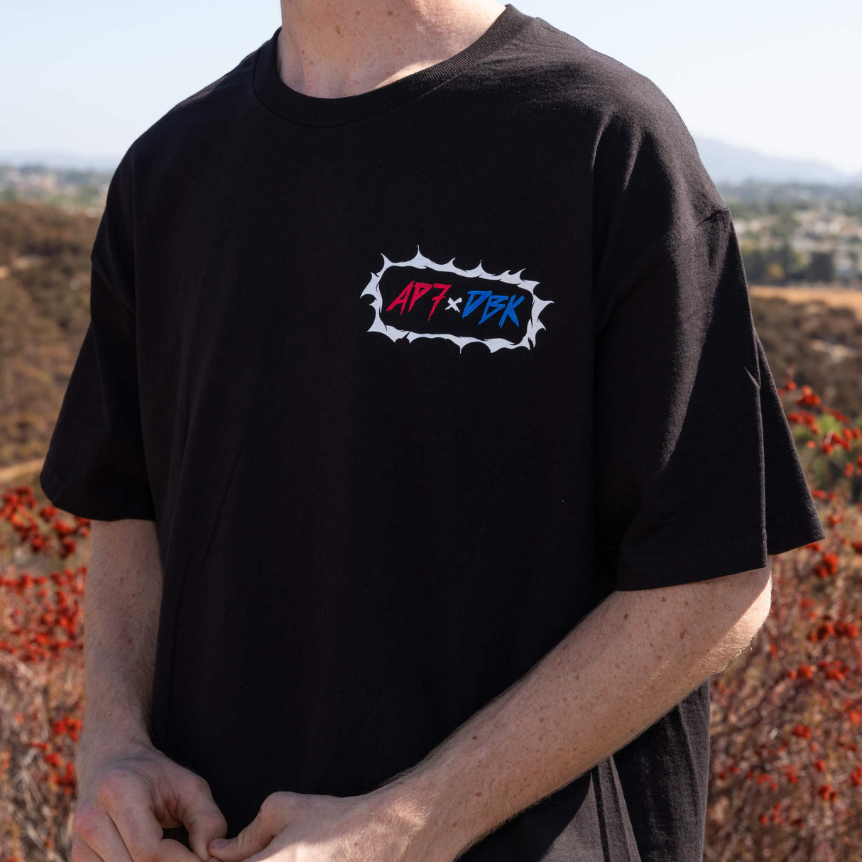 Black crew-neck T-shirt with small chest AP7+DBK logo