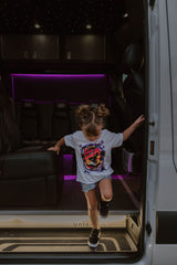 Youth girls white graphic T-shirt worn by a child with colorful motorcycle front print