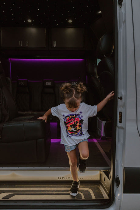 Youth girls white graphic T-shirt worn by a child with colorful motorcycle front print