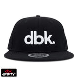 Black snapback cap with white dbk logo on the front panel.