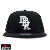 Black snapback cap with white embroidered DBK 4Fifty logo on front panel