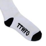 White crew sock with black toe/heel and “TTWTF” lettering across the foot.