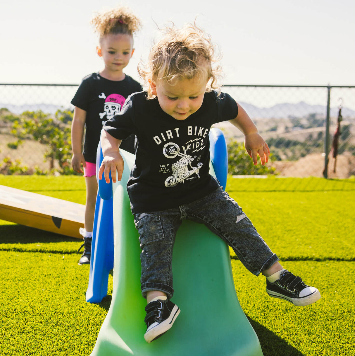 Black toddler T-shirt worn by child, front bike rider graphic and crew neckline