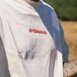 Cream T-shirt close-up with small red dirtbikekidz logo