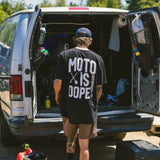 Black T-shirt worn on back with large white Moto Is Dope graphic
