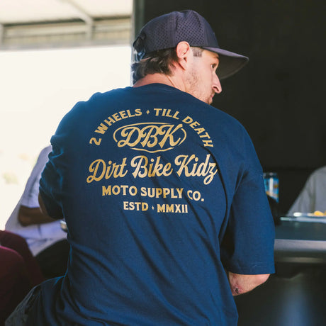 Navy Gold Nugget Tee back view with large DBK Wheels Till Death print