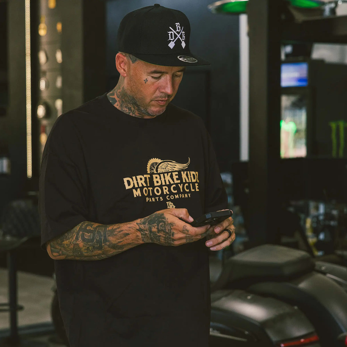 Black T-shirt worn with front dirt bike graphic logo