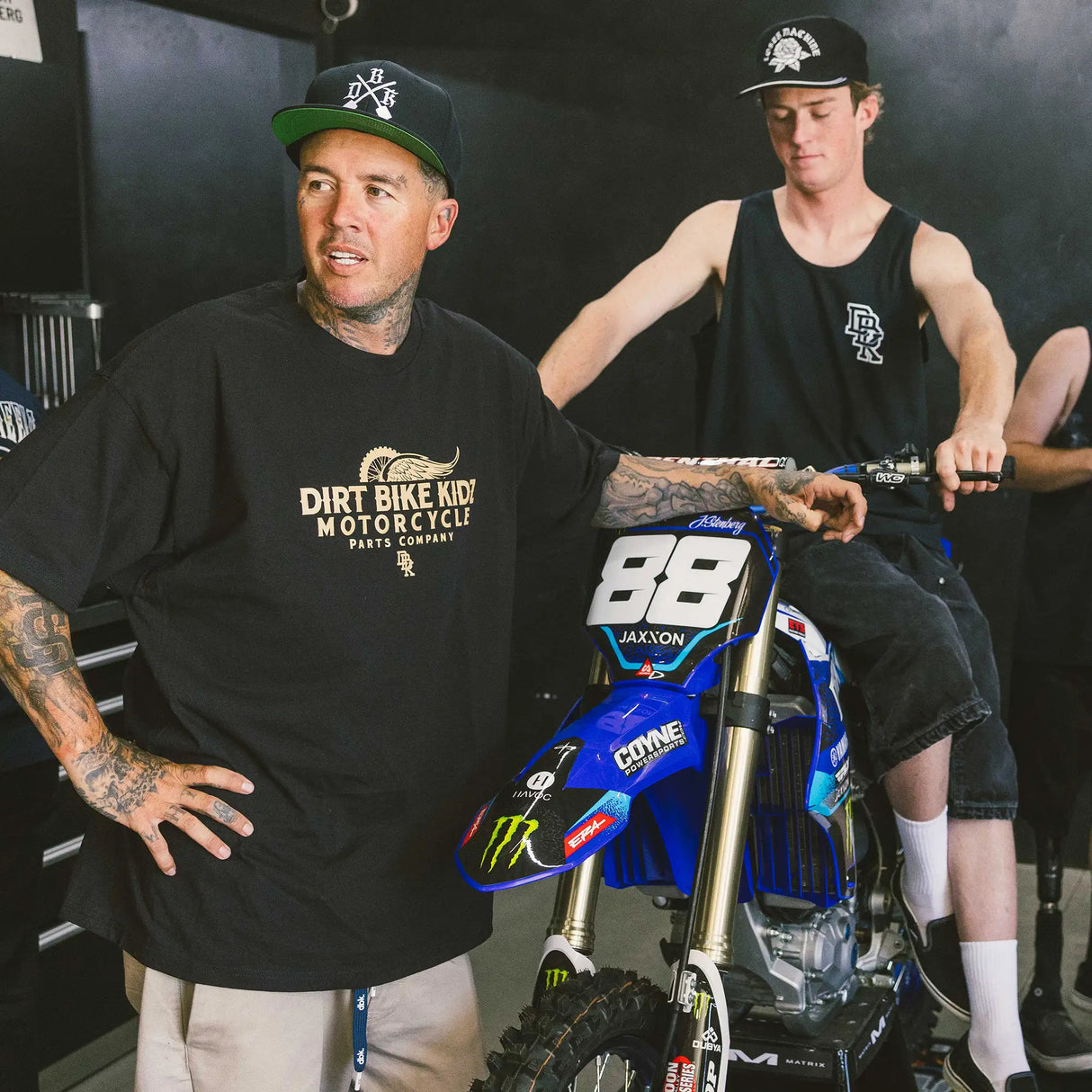Black T-shirt worn with front dirt bike graphic logo