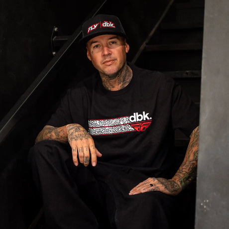 Black cap with mesh back and red/white FLY|dbk logo, worn