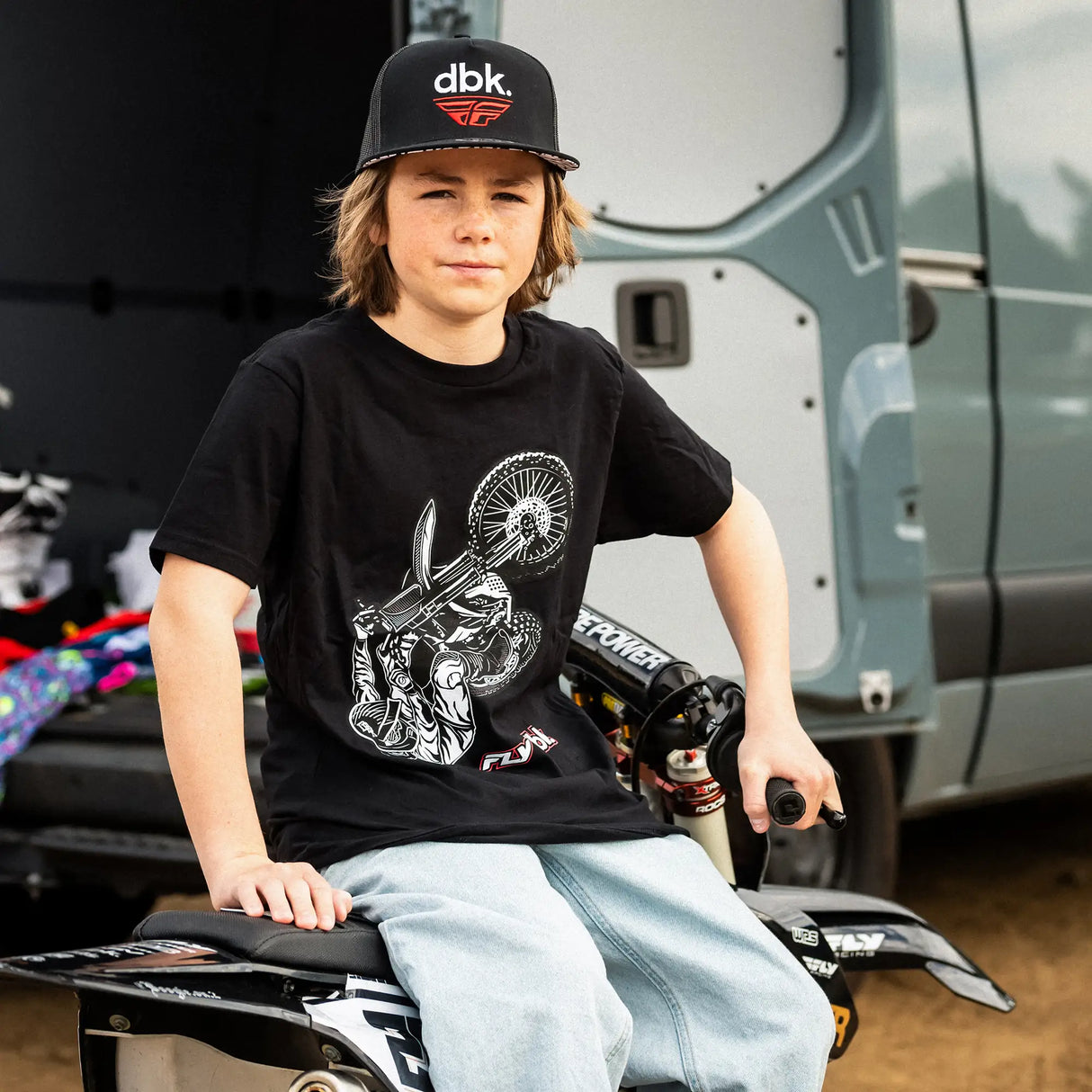 Black youth T-shirt worn with white rider wheel graphic and red FLY dbk chest logo