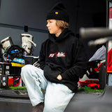 Youth black hoodie with FLY dbk logo, worn with light jeans