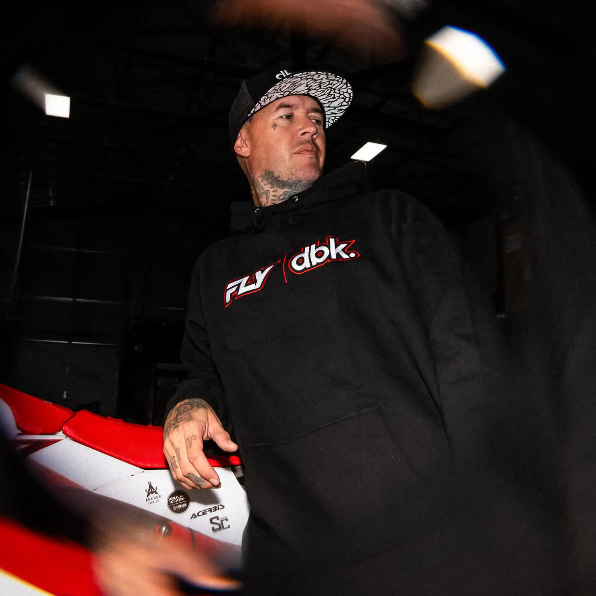 Black hoodie with red and white logo graphic on front