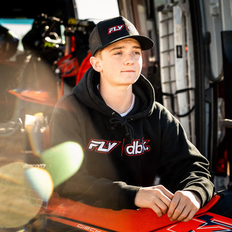 Black trucker cap with red/white FLY|dbk logo, front-left view