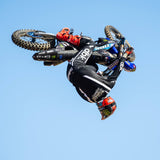 Black riding pants with white stripe details, shown while in midair