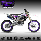 Dirt bike graphics kit on off-road motorcycle with purple, black, and white decals