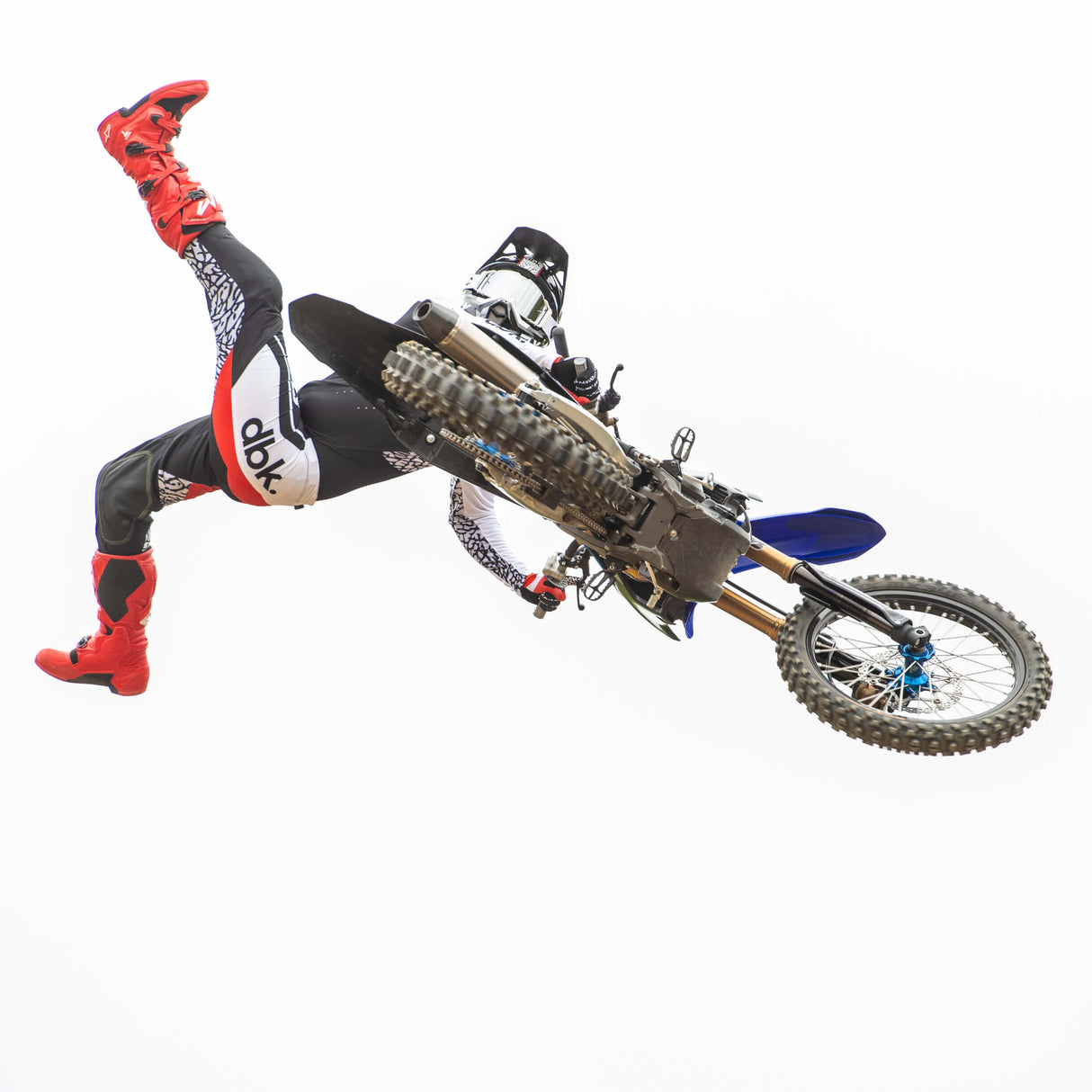Youth motocross gloves with red palms, black and white patterned backs, and knuckle panels