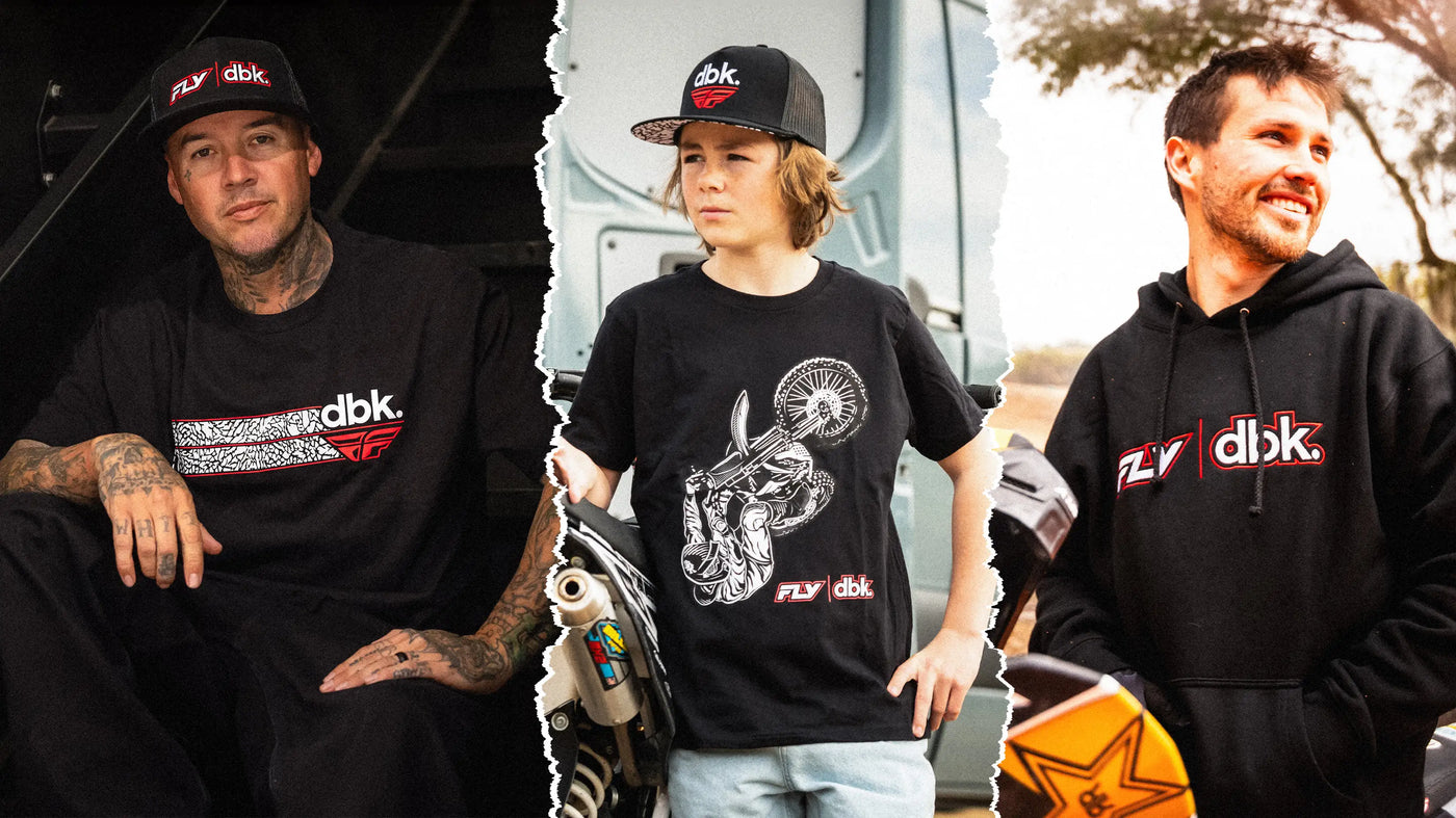 Three individuals wearing black clothing with 'fly x dbk' branding, sitting next to a motorcycle.
