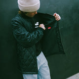 Dark quilted jacket open at front with full zipper and ribbed hem detail