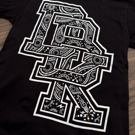 Black youth T-shirt close-up of center bandana-style graphic in white print