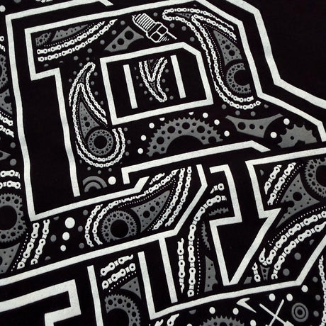 Black youth T-shirt close-up of bandana-style graphic letter detail in white ink