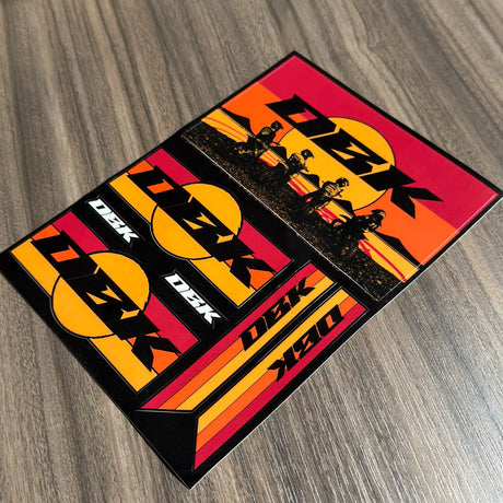 Set of D2K sticker decals with large logo, rider scene, and orange stripe designs