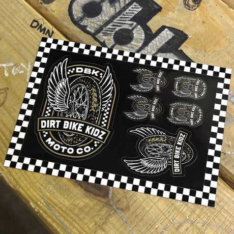 Sticker pack sheet with winged dirt bike logos and DIRT BIKE KIDZ text on a checkered border