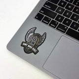Single winged dirt bike logo sticker with DIRT BIKE KIDZ text on a gray laptop lid