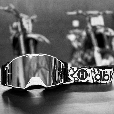 Helios goggle side view with mirrored lens and black-and-white logo strap