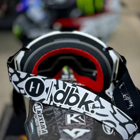 Helios goggle front close-up showing red inner foam and black-and-white strap