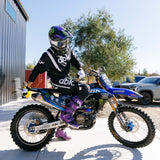 Black motocross pants with bold white dbk lettering and armored knee area