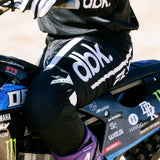 Black kinetic mesh pant with large white dbk logo and textured knee panel