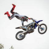 Motocross jersey in light gray and black with red accents on sleeves and side paneling while riding