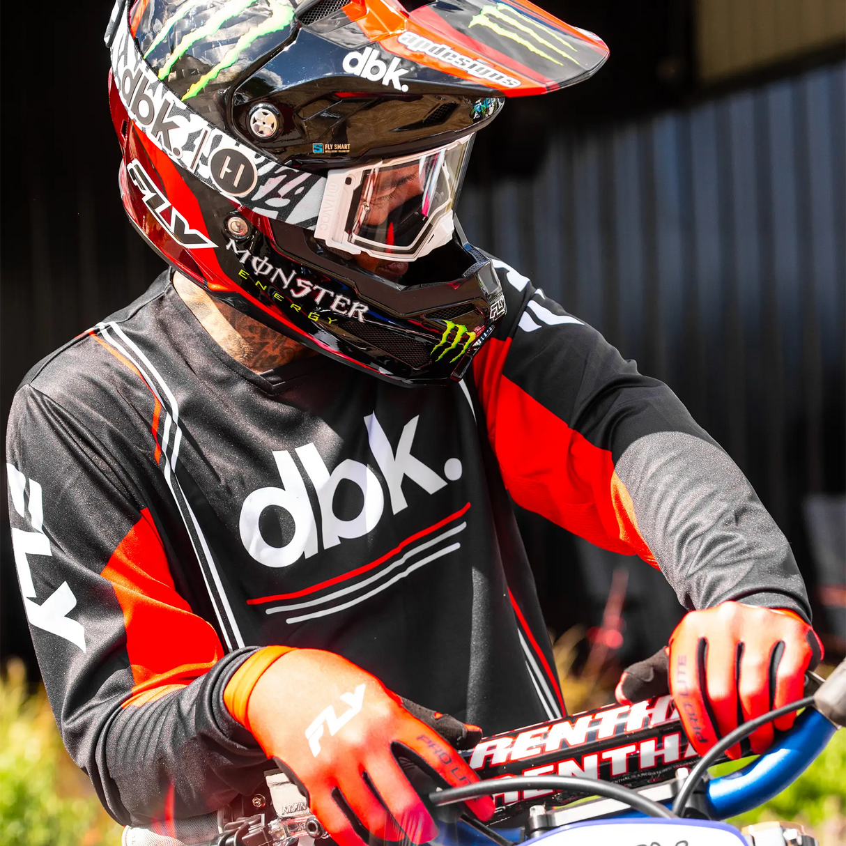 Black and red long-sleeve motocross jersey with gray sleeves and dbk logo on chest